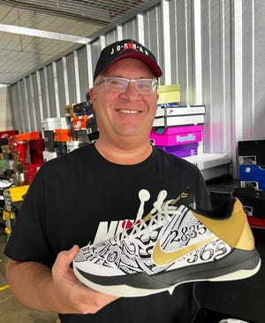 John Hray, coordinator of the Stark County Sneaker and Clothing XPO, holds one of the hundreds of Nike athletic shoes that will be for sale during the event Sunday at the Canton Memorial Civic Center.