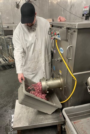 Zach Morelli makes sausage at Postiy's Fine Food & Meats in Plain Township. Postiy's makes about 3,500 pounds of sausage per week.