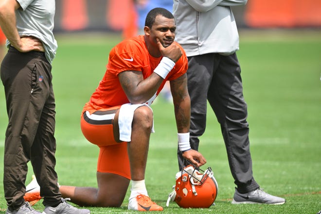 FILE - Cleveland Browns quarterback Deshaun Watson kneels on the field during an NFL football practice at the team's training facility on June 8, 2022, in Berea, Ohio.
