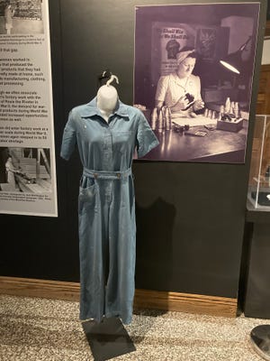 A panel and artifacts in the upcoming "Women at Work" exhibition in the Keller Gallery at McKinley Museum illustrates how women served in factories making war goods. The worker's jumpsuit is on loan from the Timken Co.