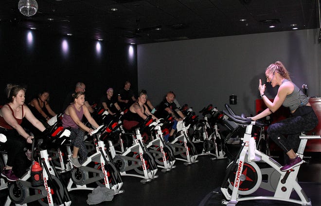 Folks participate in a charity ride at CycleBar in Hendersonville, Tennessee, in March 2022.