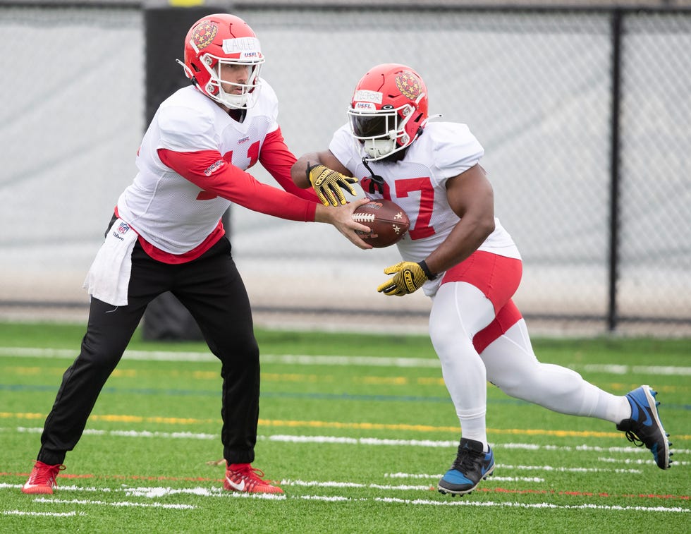 New Jersey Generals quarterback Kyle Lauletta hands off to running back Darius Victor at practice, Friday, March 24, 2023, in Canton.