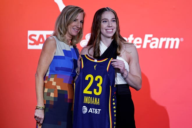 Ohio State's Taylor Mikesell (right) poses for a photo with commissioner Cathy Engelbert after being selected by the Indiana Fever at the WNBA Draft on Monday in New York. (AP Photo/Adam Hunger)