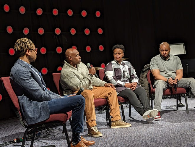 Malone University Associate Professor Bryson Davis (l) speaks with panelists LaMarr Atchison, Shauntae D. Metcalf and Donovan Harris of South Street Ministries of Akron during a post-prison reentry workshop held recently at Malone